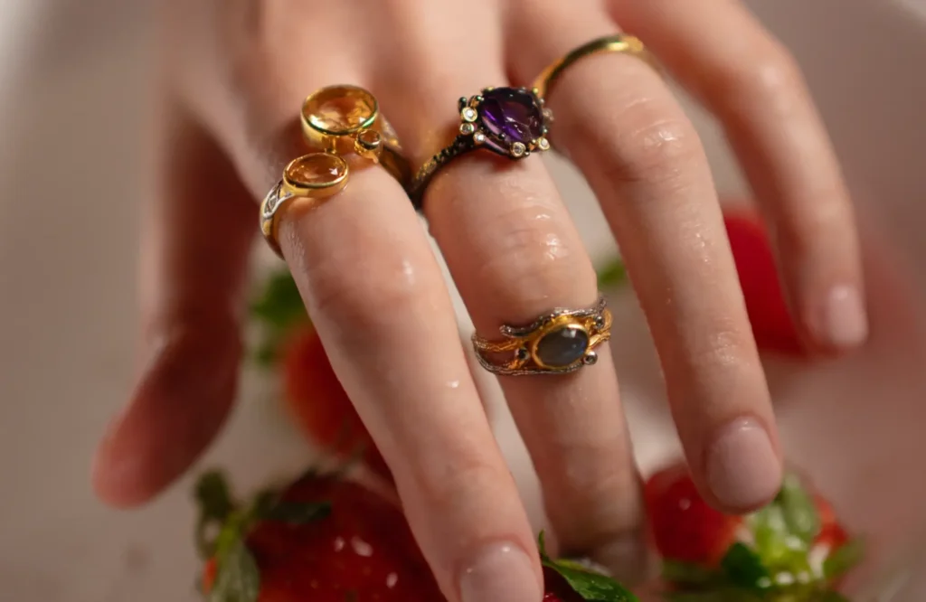 Hand adorned with elegant gemstone rings, perfect choice for gemstone rings for wedding gifting India.