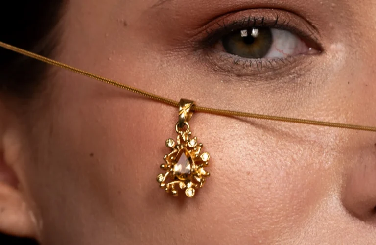 A woman wearing an elegant gold pendant necklace, showcasing luxury jewelry perfect for Diwali gifting.